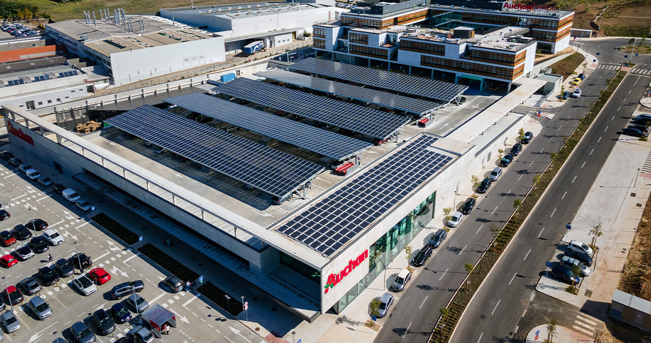 aerial view of auchan retail with solar panels